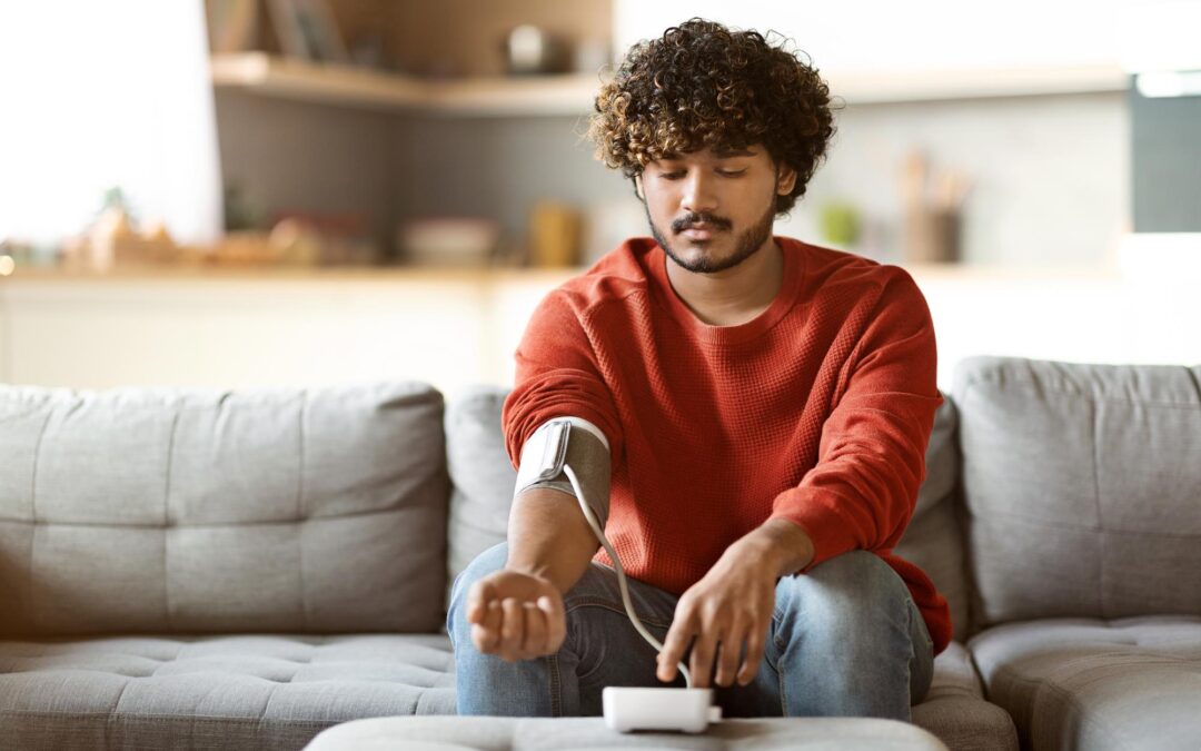 Man taking blood pressure reading, beta blockers and alcohol